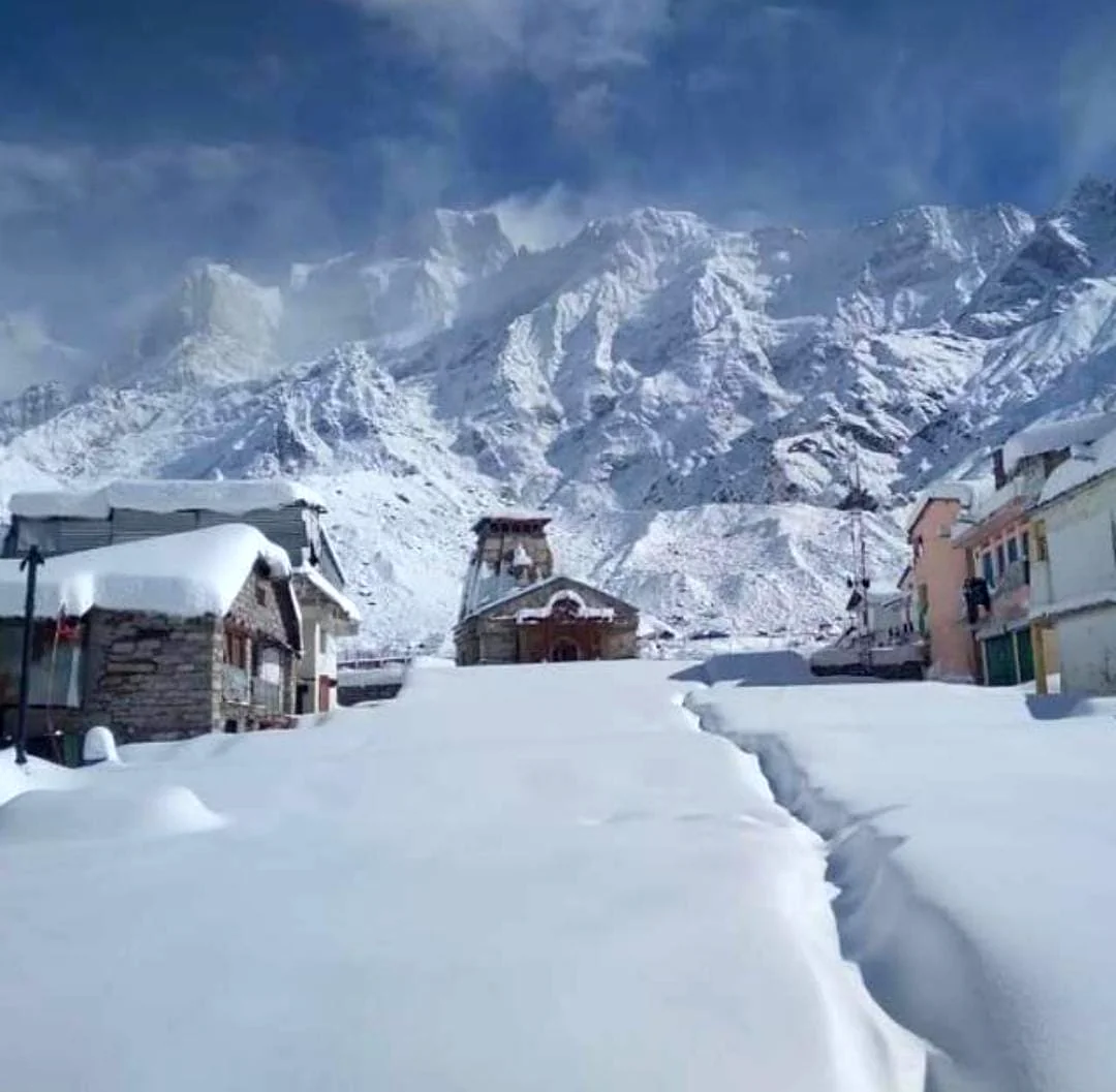 Snow-covered Kedarnath temple with deep Himalayan snowpack and peaks behind, Uttarakhand